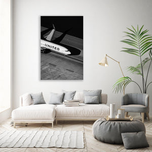 a living room with a white couch and a black and white airplane