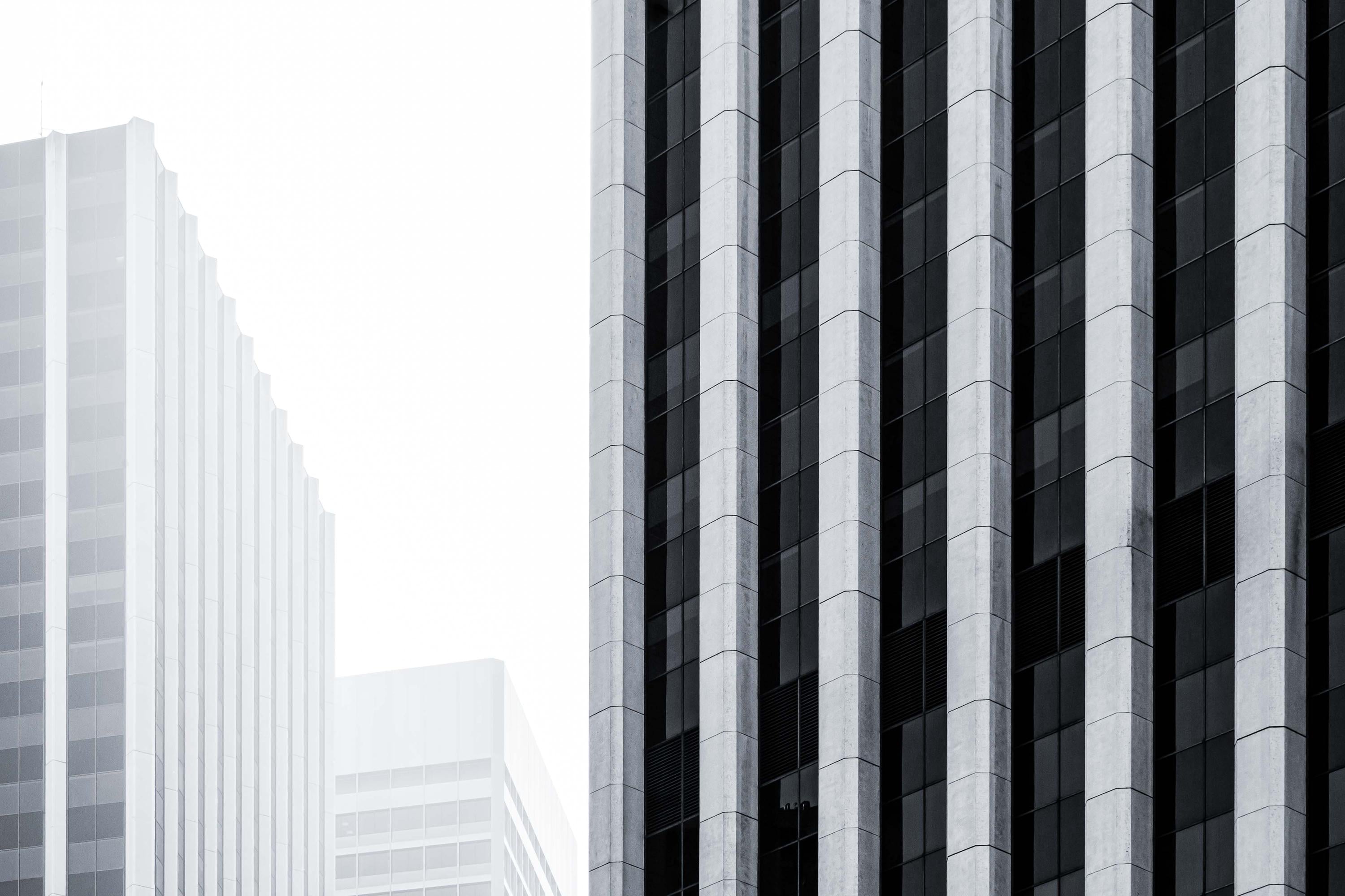 a black and white photo of tall buildings