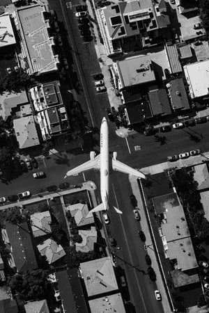 an aerial view of an airplane flying over a city