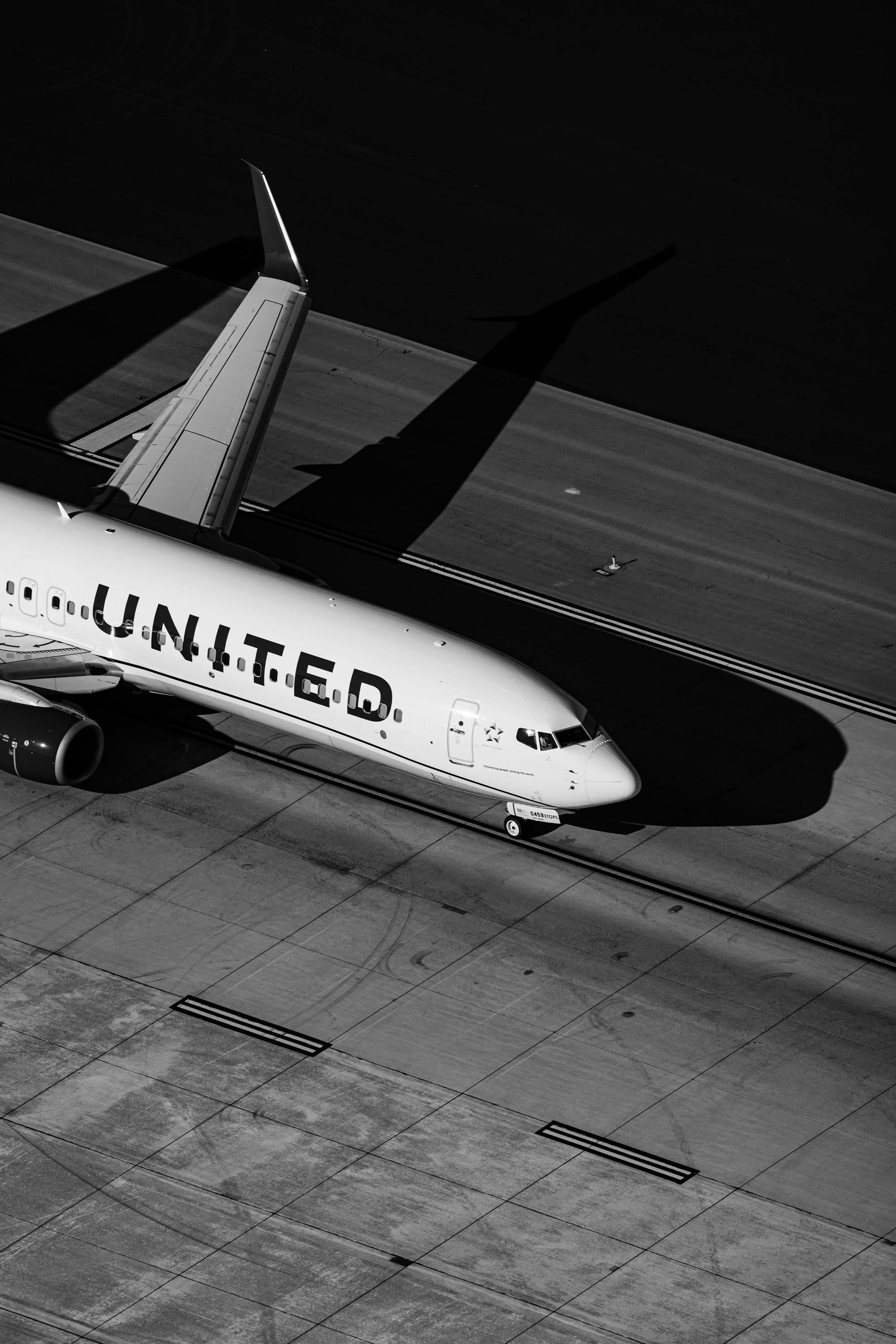 a united airlines jetliner sitting on top of an airport tarmac