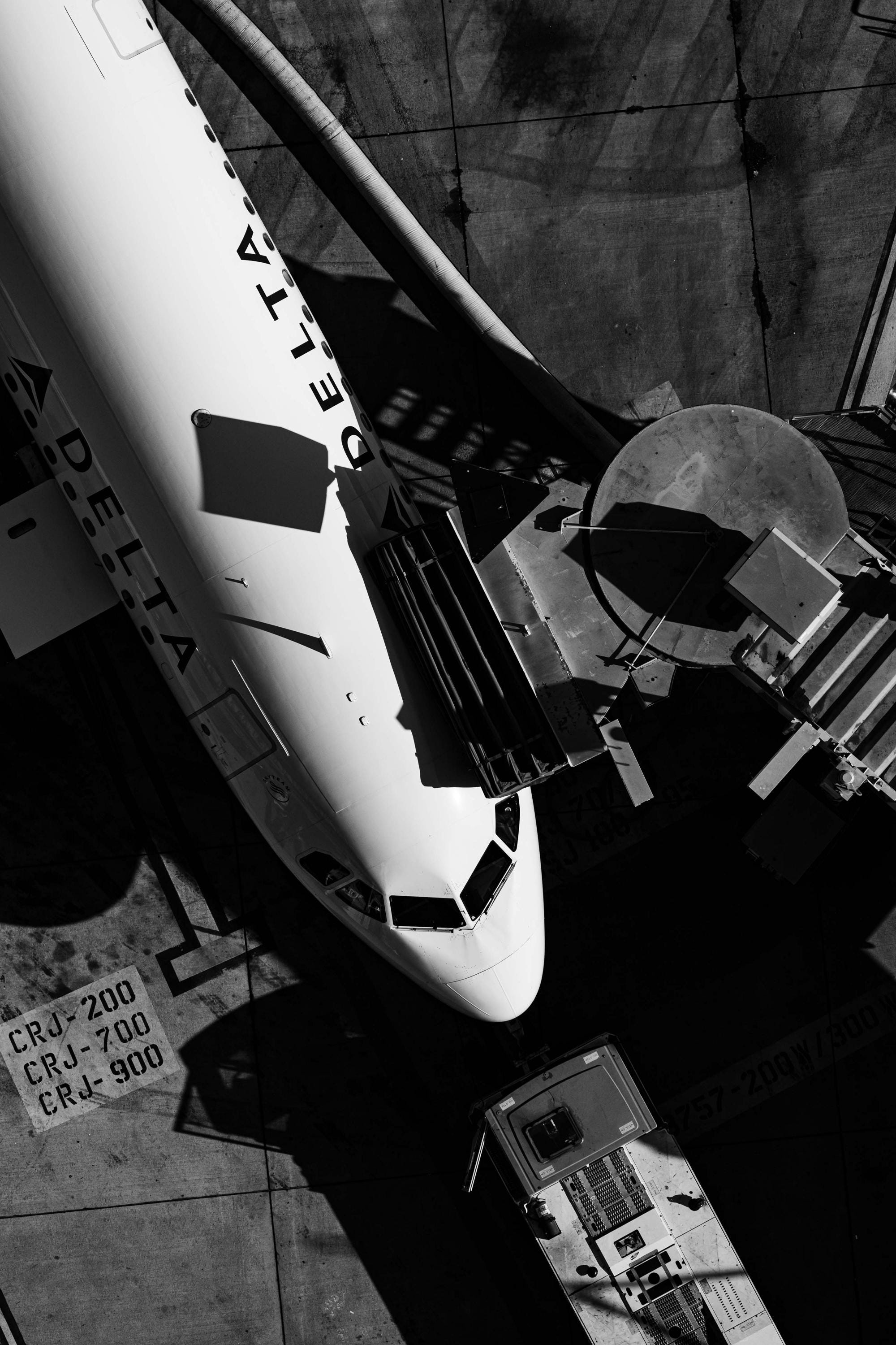 Delta Air Lines at San Diego International Airport Gate - Black and White Aerial Photography by Toby Harriman (Metal & Bamboo Prints)