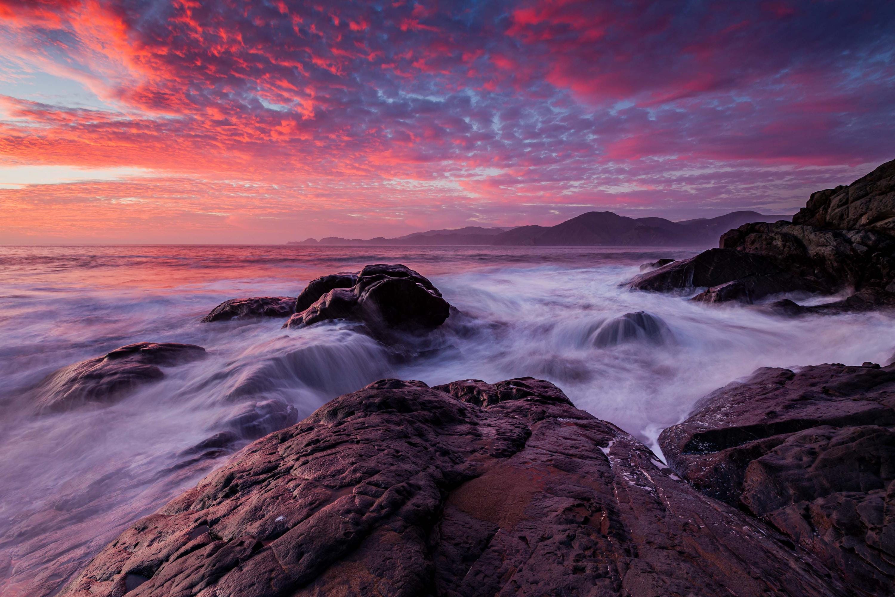 a red and purple sunset over the ocean