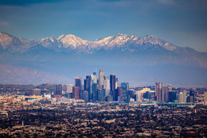 a view of a city with mountains in the background