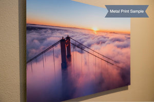 a picture of the golden gate bridge above the clouds