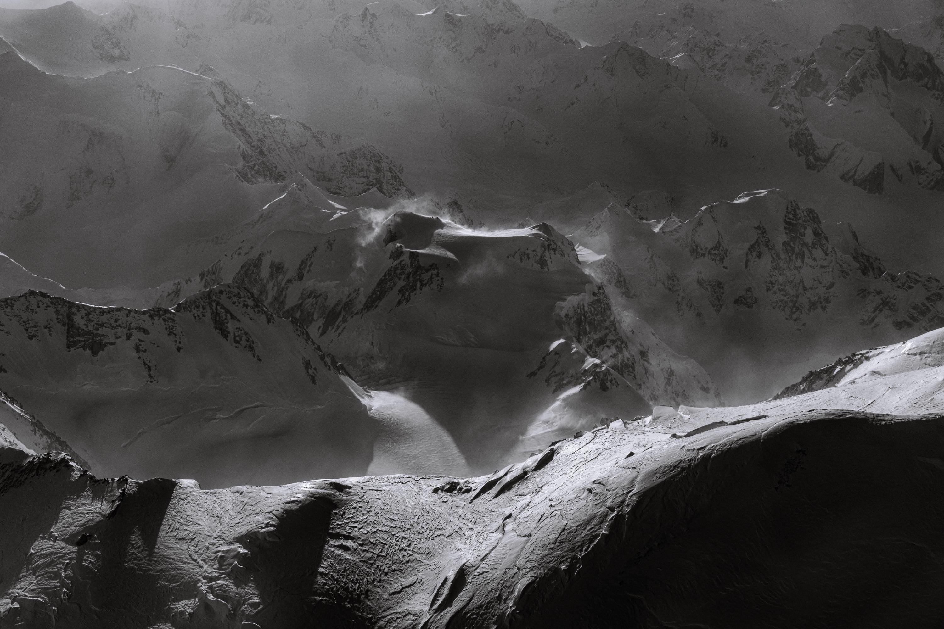 a black and white photo of a mountain range