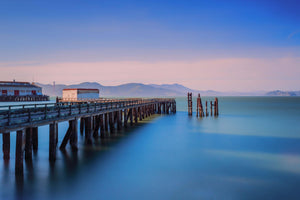 a long pier stretching out into the ocean