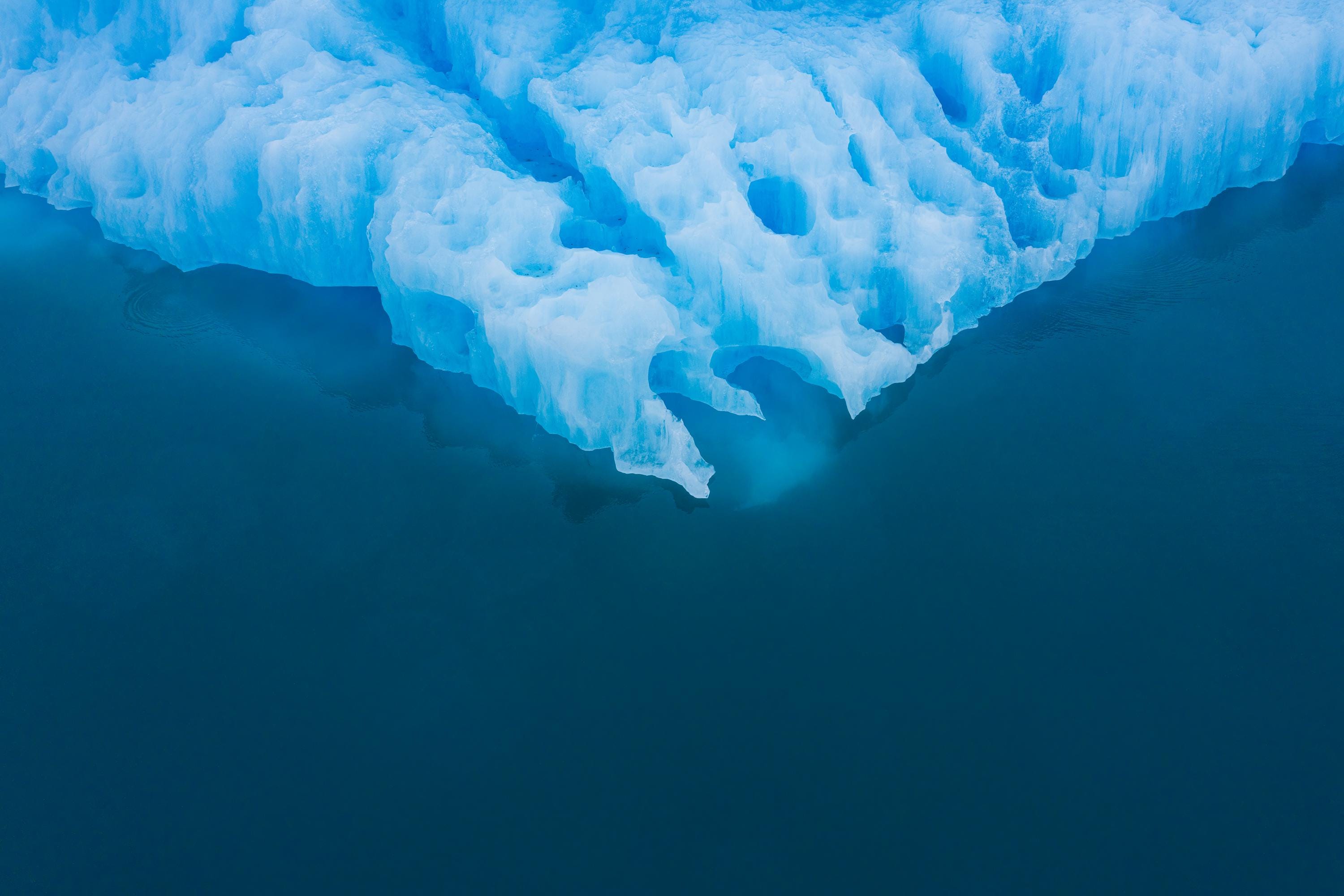 a large blue iceberg floating in the ocean