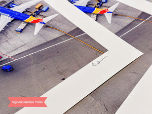 a group of airplanes sitting on top of an airport tarmac